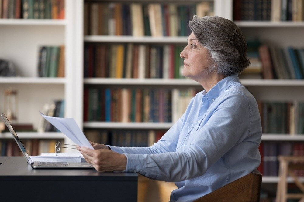 Older woman notifying mortgage company of death.