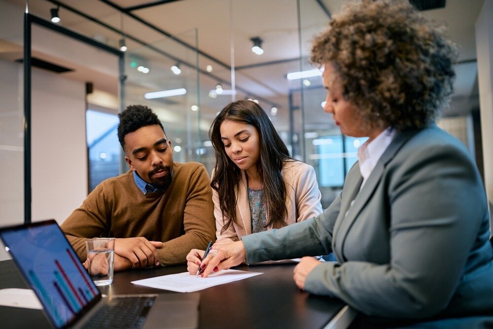 Couple working with a professional to boost financial credibility.