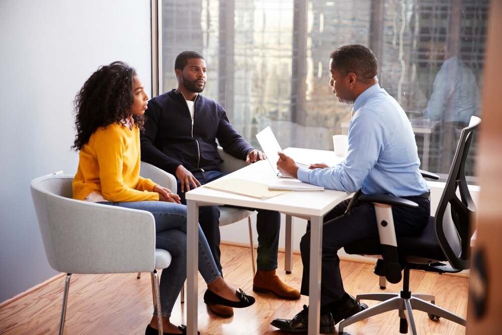 Couple meeting with lender about notice of default.