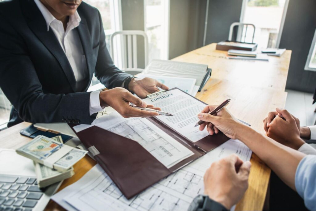 Customer signing contract documents for realty purchase