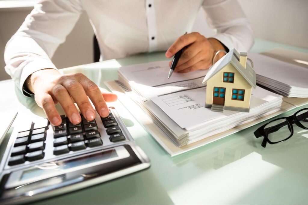 Close up of accountant calculating property tax using a calculator