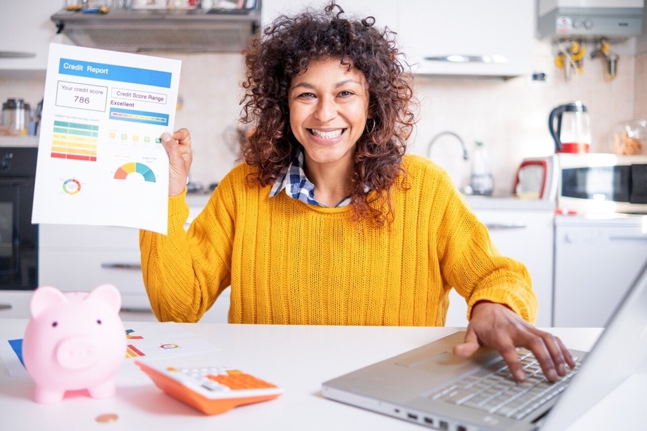 Happy black woman checking her good credit score online