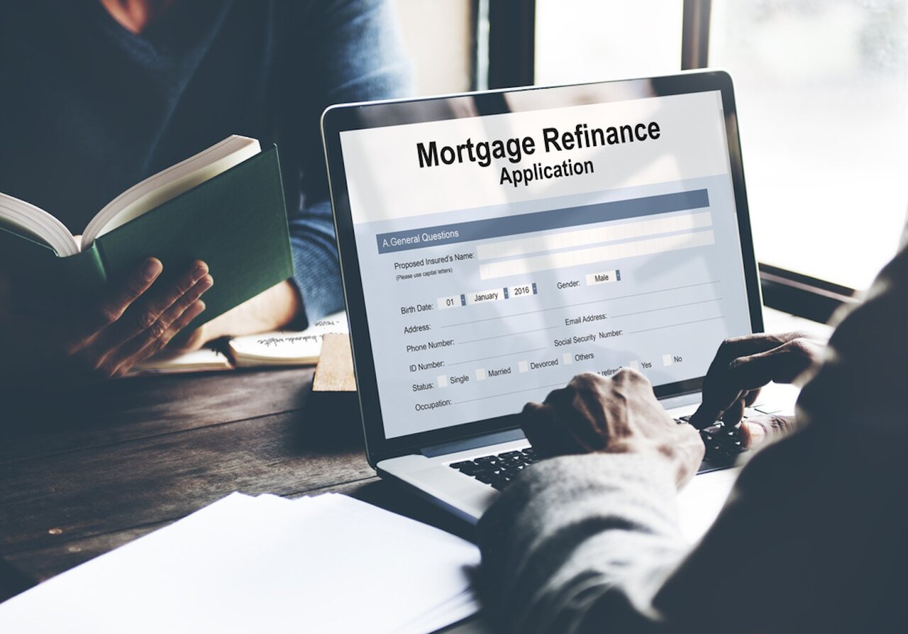 Close up of someone filling out a mortgage refinance application on their laptop.