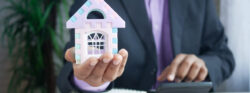The,Concept,Of,Finance,Concept,,,Man,Holding,House,In