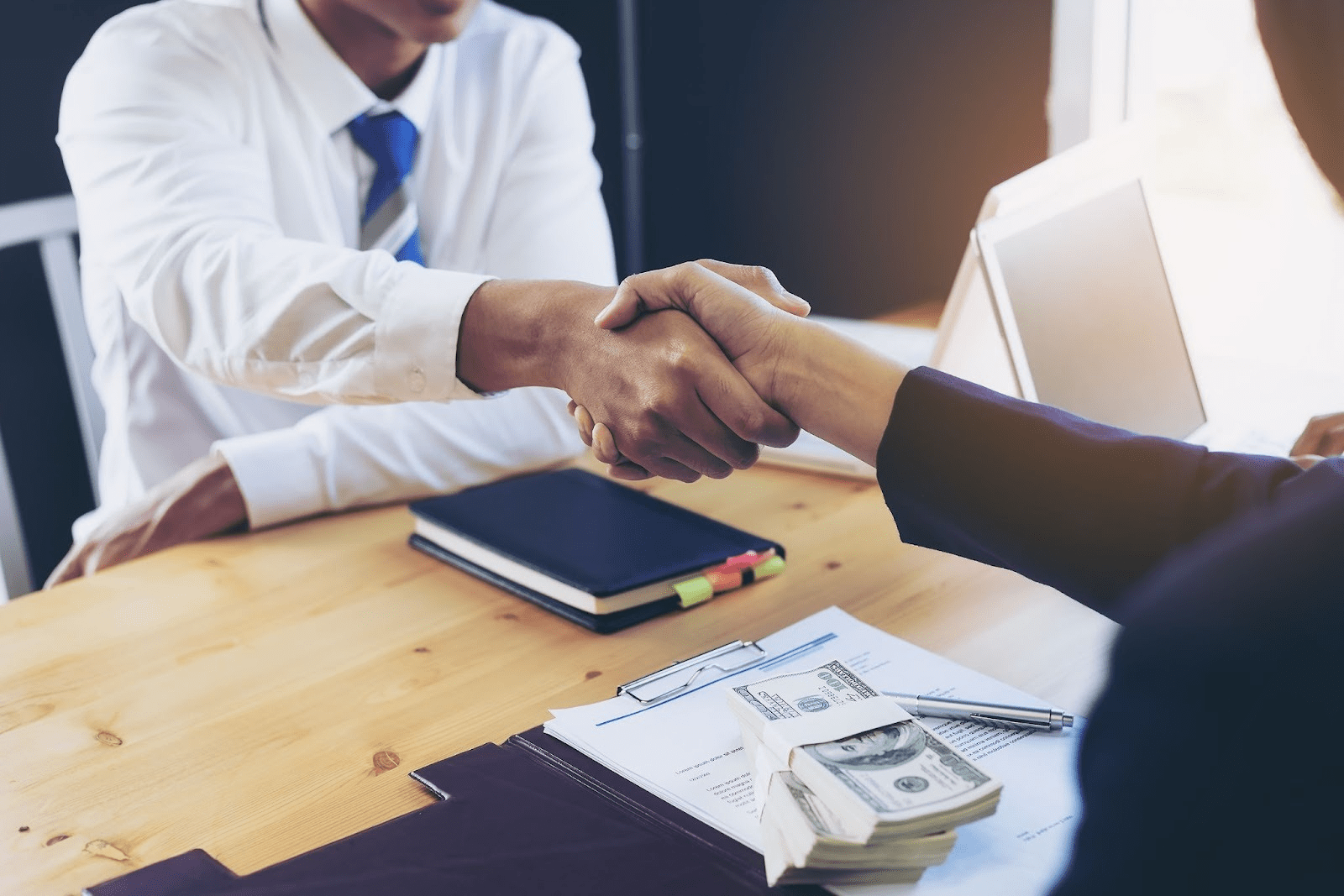 2 people shaking hands over a loan