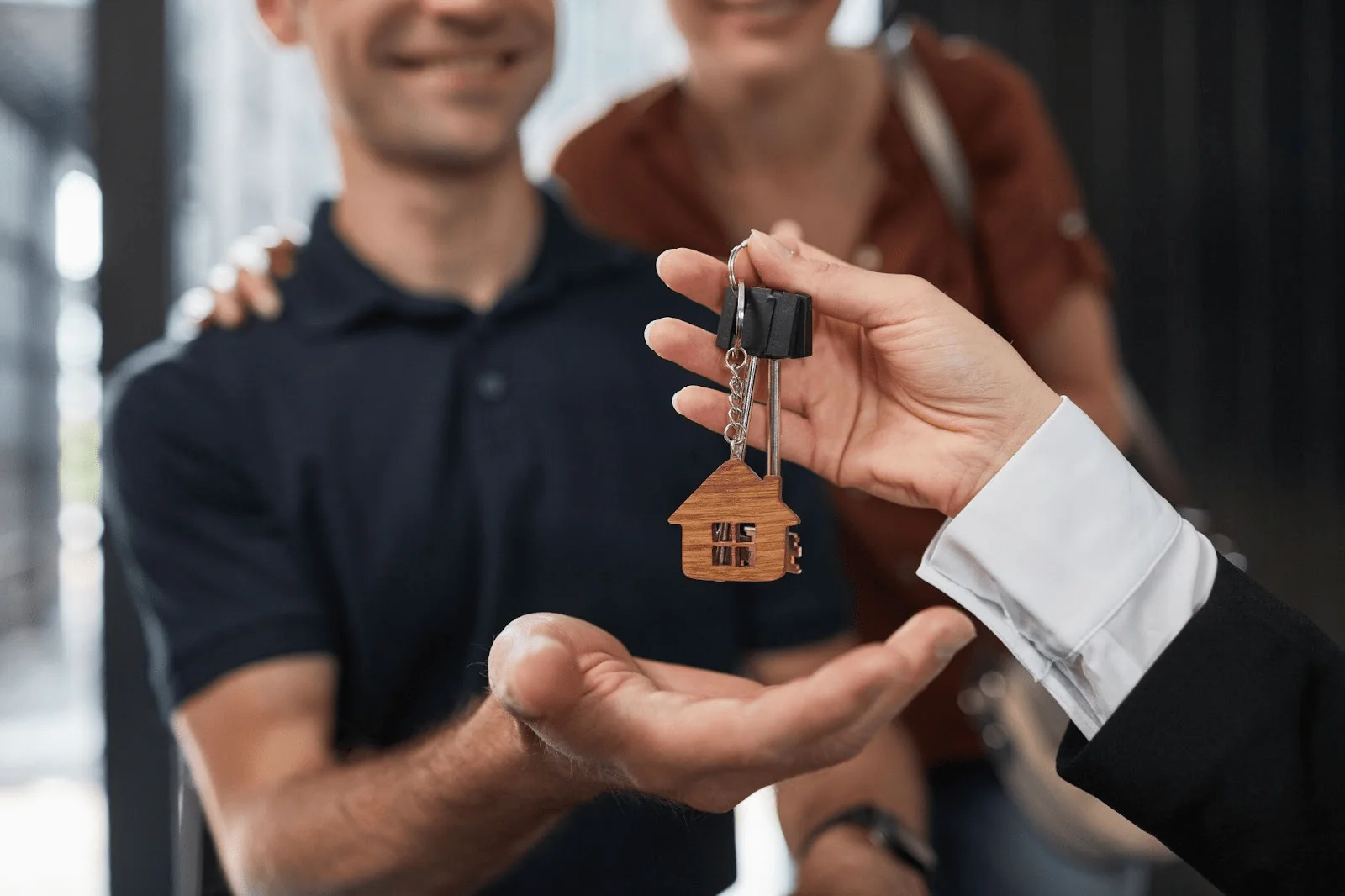 A couple receiving a new set of house keys. 