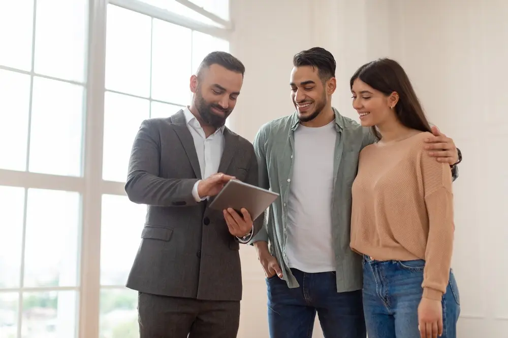 Young home buyers speaking with a realtor.