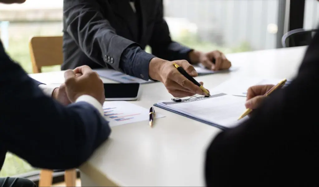A mortgage professional reviewing financial documents with clients.