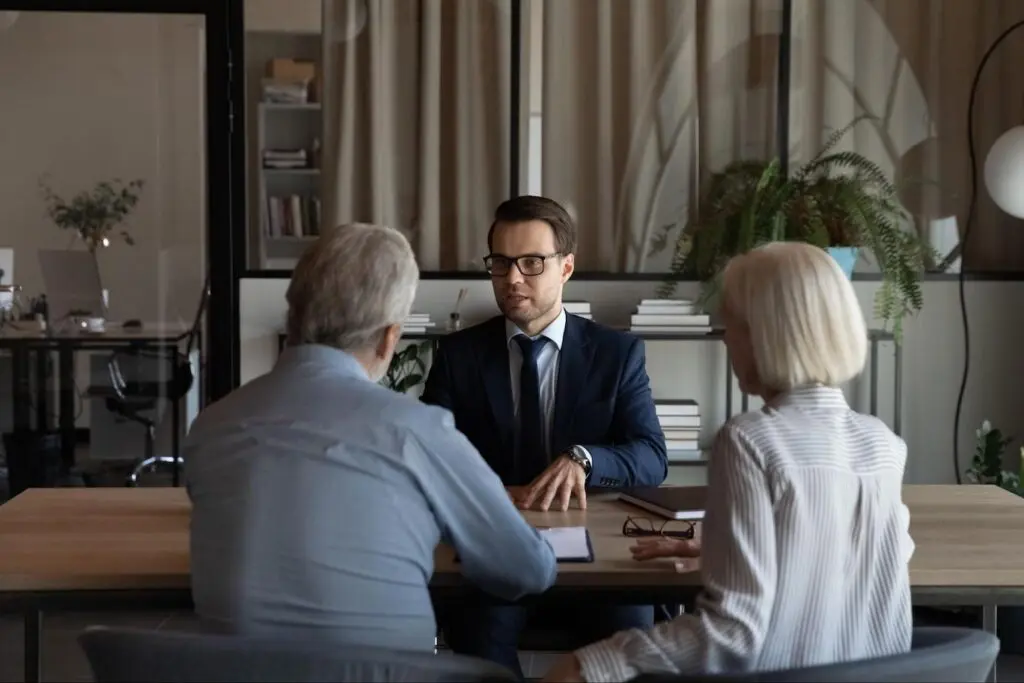 Mortgage expert speaking to an older couple about easement by prescription.