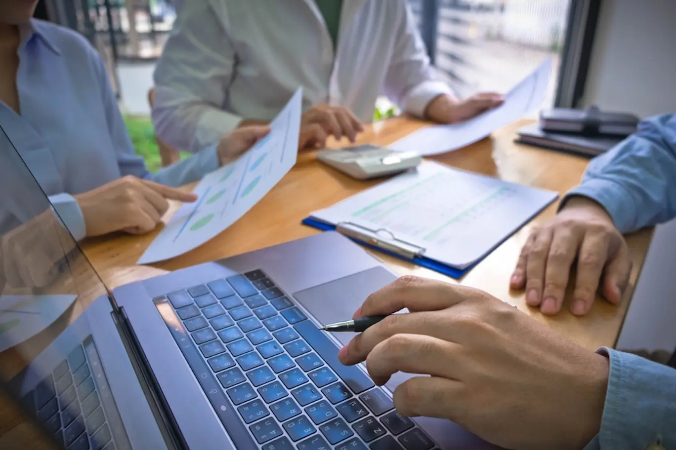 Image of people reviewing documents at a table.